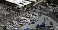  ?? MARCIO JOSE SANCHEZ — THE ASSOCIATED PRESS FILE ?? Pacific Gas & Electric crews work on restoring power lines in a fire ravaged neighborho­od in an aerial view in the aftermath of a wildfire in Santa Rosa.