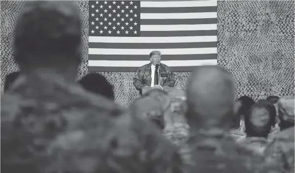  ?? ANDREW HARNIK / THE ASSOCIATED PRESS FILES ?? President Donald Trump speaks to members of the military in December at a hangar rally at Al Asad Air Base, Iraq.