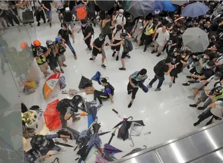  ?? Photo: AP ?? Protesters scuffle with Police officers inside a shopping mall in Hong Kong.