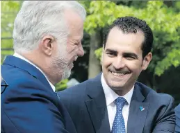  ?? PIERRE OBENDRAUF ?? Premier Philippe Couillard greets Monsef Derraji, the new Liberal candidate for the riding of Nelligan in Pierrefond­s on Tuesday.