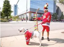  ?? JAMES FOSTER/FOR THE SUN-TIMES ?? Ann Riffle and Cindy Kemphues (left) and David Salazar (right, with dog Casper) were among the hundreds of people who waited outside the United Center (below) on Sunday to pay their respects to Mikita.