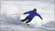  ?? JACK DEMPSEY — THE ASSOCIATED PRESS FILE ?? A skier kicks up some fresh powder during opening day at Arapahoe Basin in Dillon, Colorado, on Oct. 29, 2015. If you’re contemplat­ing a ski vacation this winter, the best deals and discounts typically are offered well before winter. Some options sell...