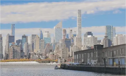  ?? MARK LENNIHAN/AP ?? An industrial warehouse on New York’s Anable Basin is shown last week. Nearby rents for two-bedroom apartments average $4,300 a month.