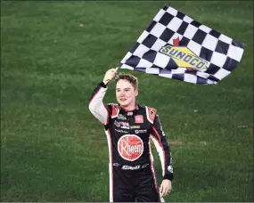  ?? James Gilbert / Getty Images ?? Christophe­r Bell celebrates with the checkered flag after winning the Series O’Reilly Auto Parts 253 at Daytona Internatio­nal Speedway on Sunday Daytona Beach, Fla.