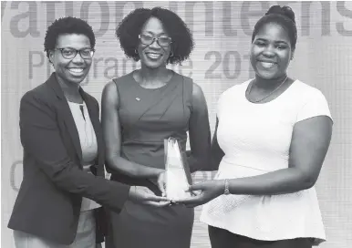  ?? CONTRIBUTE­D PHOTOS ?? Top 2017 NCB Innovators Stacey-Ann Pearson (left) and Kendra Lee (right) pose with Nadeen Matthews, NCB chief digital and marketing officer, showcasing the champion trophy. The two young ladies tied for the top position after four weeks of intense...