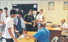  ??  ?? Players for the qualifying matches signing in before tournament referee Abhishek Mukherjee (right) and paying their entry fees to official Bong Vui Khee (second right) at the SLTA Tennis Centre conference room yesterday.