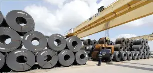  ?? — AP ?? A roll of steel is unloaded at a manufactur­ing facility in Baytown, Texas.