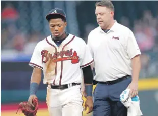  ?? AP ?? Ronald Acuña Jr., de los Bravos, mientras abandonaba el partido tras recibir un pelotazo abriendo el juego de parte de José Ureña.