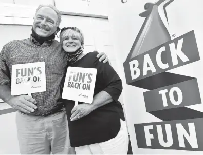  ?? AMY DAVIS/BALTIMORE SUN ?? Robert and Nancy Houchens, of North Garden, Virginia, who have been on more than 200 cruises together, were selected to cut the ceremonial ribbon marking the return of Carnival Pride to Baltimore.