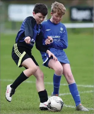  ??  ?? Alex Sheehan, Inter Kenmare, goes up against Killarney Athletic’s Sean White in their Kerry Schoolboys League Under- 12 game at Woodlawn, Killarney earlier this year