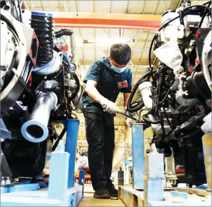  ?? WANG KAI / XINHUA ?? A technician works at a vehicle production plant in the Shandong FTZ in Jinan, Shandong province.