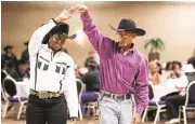  ?? Mayra Beltran / Houston Chronicle ?? Angela Lathan and Byron Miller dance during Southwest Trail Rider’s Associatio­n’s kick-off party before last year’s trail ride from Fort Bend County to the Houston Livestock Show and Rodeo. This year, the group embarks from Rosenberg on the 120-mile...