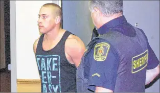  ?? TELEGRAM FILE PHOTO ?? Philip Smith is led into court in St. John’s in June.