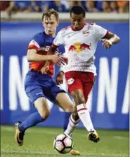  ?? JOHN MINCHILLO — THE ASSOCIATED PRESS FILE ?? In this file photo, New York Red Bulls midfielder Tyler Adams, right, shields for the ball against FC Cincinnati midfielder Jimmy McLaughlin, left, during the second half of a U.S. Open Cup semifinal soccer match in Cincinnati. Josh Sargent remembered...