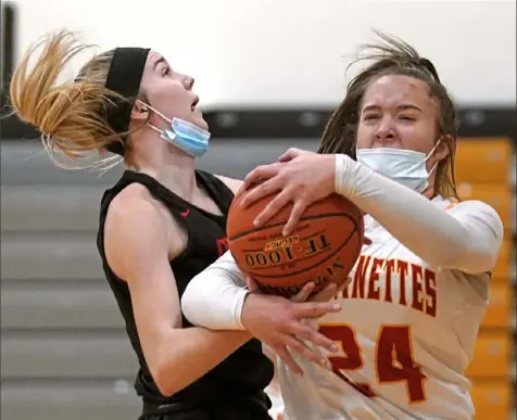  ?? Peter Diana/Post-Gazette ?? North Catholic’s Ava Walker, right, battles for rebound with Mohawk’s Jordan Radzmynski Thursday in a meeting between the top two teams in WPIAL Class 3A. No. 2 North Catholic defeated No. 1 Mohawk, 54-38.