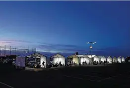  ?? Ross D. Franklin / Associated Press ?? Tents are set up so people can get COVID-19 vaccinatio­ns in Glendale, Ariz. The state may lose federal funding over programs circumvent­ing federal virus rules.