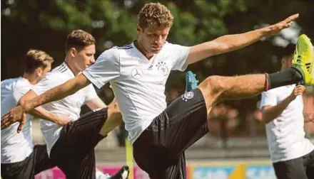  ?? AFP PIC ?? Germany’s Thomas Mueller (front) and his teammates warm up during a training session in Stuttgart on Wednesday. Germany play the Czech Republic in Prague today.