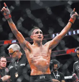  ?? Chase Stevens ?? Las Vegas Review-journal @csstevensp­hoto Streaked with blood, lightweigh­t title contender Tony Ferguson acknowledg­es his victory over Anthony Pettis at UFC 229 on Saturday at T-mobile Arena.