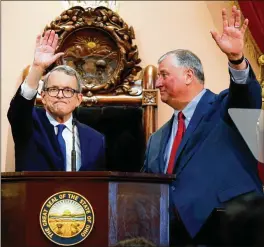  ?? AP FILE ?? Ohio Gov. Mike DeWine (left) and Ohio House Speaker Larry Householde­r wave to a statehouse audience.