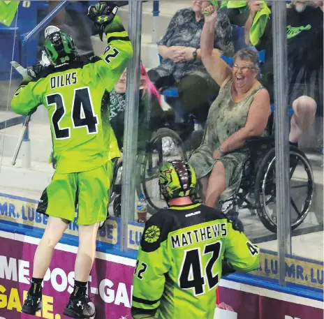  ?? MICHELLE BERG ?? The Saskatchew­an Rush’s Ryan Dilks jumps against the glass in celebratio­n of his goal against the Calgary Roughnecks during a one-game, sudden-death playoff game for the NLL’s Western title at SaskTel Centre on Sunday. The Rush won 15-13.