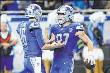  ?? Duane Burleson
The Associated Press ?? Lions quarterbac­k Jared Goff, left, greets tight end Sam Laporta after his 10-yard touchdown reception in the fourth quarter Saturday in Detroit.