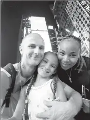  ?? Special to the Democrat-Gazette/Wezowicz family ?? Matthew, Karma and Renata Wezowicz stand in Times Square in New York City at the end of August while on vacation before Karma started first grade.