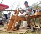  ??  ?? Bobby Edwards uses a shaving horse and draw knife to prepare wood for splitting. Edwards makes woven baskets as a hobby.