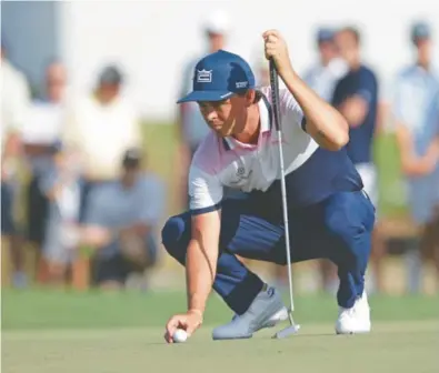  ?? JOHN MCCALL/SUN SENTINEL ?? Jupiter resident Rickie Fowler, the world’s ninth-ranked golfer, surveys one of PGA National’s refurbishe­d greens on the 11th hole on Thursday.