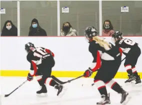  ?? TIM KROCHAK / BLOOMBERG ?? Parents wear protective masks while watching their children play hockey in Dartmouth, N.S., on Saturday. The province now has 45 confirmed cases of COVID-19.