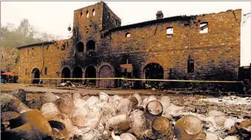  ?? JUSTIN SULLIVAN/GETTY ?? Burned wine glasses sit in a pile in front of a building at Castello di Amorosa that was destroyed by the Glass Fire on Oct. 1 in Calistoga, California. The fire has burned 56,000 acres in Sonoma and Napa counties and has destroyed numerous wineries.