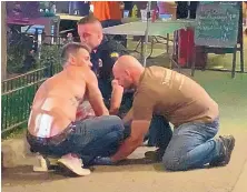  ?? JEFF OAKS/ASSOCIATED PRESS ?? Emergency workers and a bystander help an injured person after a shooting in Dayton, Ohio, early Sunday.