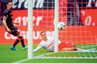  ?? AFP ?? Leipzig’s Yussuf Poulsen scores a goal against Bayer 04 Leverkusen.—