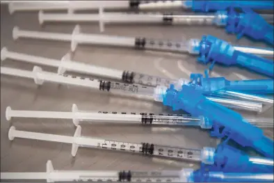  ?? Patrick T. Fallon / AFP/TNS ?? Syringes with doses of a COVID vaccine.