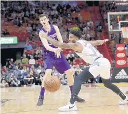  ?? LYNNE SLADKY/AP ?? Heat forward Rodney McGruder tries to deflect the pass of Suns forward Dragan Bender during the first half of Monday’s game.
