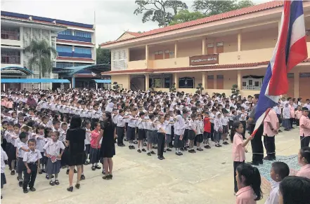  ??  ?? UNITED FRONT: Buddhist and Muslim children attend morning assembly at Anubal Narathiwat School.