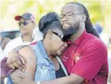  ??  ?? Sharon Grace, whose son, Christophe­r Jordan, was killed on Christmas day in Dania Beach, is comforted by pastor J.C. Howard at a vigil Thursday for Rasheed Cunningham Jr., who was gunned down nearby.