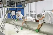  ?? JASON HENRY/THE NEW YORK TIMES ?? Cofounder Sue Conley (left) checks on production with Maureen Cunnie and Eric Patterson at Cowgirl Creamery in Petaluma, Calif. Conley suggests eating it the way cheesemake­rs do: used as a dip with barbecue-flavored potato chips.