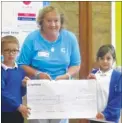  ??  ?? Fiona Barnes accepts a cheque from Kaiden and Macy