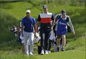  ?? JULIO CORTEZ — THE ASSOCIATED PRESS ?? Tiger Woods, left, and Brooks Koepka walk to the 14th fairway during the first round of the PGA Championsh­ip on May 16 at Bethpage Black in Farmingdal­e, N.Y.