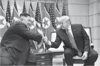  ?? Susan Walsh / Associated Press ?? President Donald Trump meets with North Korean leader Kim Jong Un in the border village of Panmunjom in the Demilitari­zed Zone on Sunday, when the leaders agreed to resume nuclear talks.