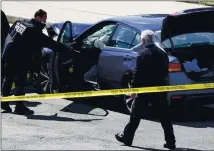  ?? J. SCOTT APPLEWHITE — THE ASSOCIATED PRESS ?? U.S. Capitol Police officers stand near a car that crashed into a barrier on Capitol Hill in Washington on Friday.