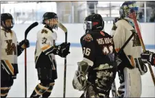  ?? JEANS PINEDA/Taos News ?? LEFT: Case Cook dribbles past a couple of Los Alamos players. RIGHT: Taos and Los Alamos shake hands after their second round of matches on Sunday (Jan. 29).