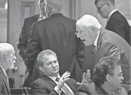  ??  ?? Rep. Charles Sargent, left, gets animated as he talks with Rep. Jerome Moon and Rep. Tim Wirgau on April 24 in Nashville. LARRY MCCORMACK / THE TENNESSEAN