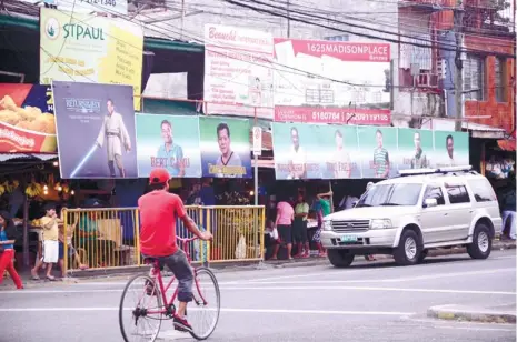  ?? (SUN.STAR FOTO/RUEL ROSELLO) ?? POLITICS AND SHOW BUSINESS. Campaign posters hang from the market in Banawa, Guadalupe in Cebu City, including one that might prompt Star Wars fans to ask, “Is the Force strong in this one?”