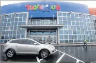  ?? AP PHOTO ?? In this 2017 file photo, a woman leaves a Toys R Us store in Elizabeth, N.J. Toys R Us, squeezed by Amazon.com and huge chains like Walmart, will close 180 stores, or about 20 percent of its U.S. locations, within months, the company announced Wednesday.