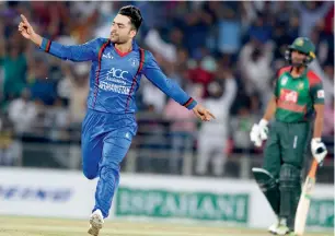  ?? AFP ?? Afghanista­n’s Rashid Khan celebrates the wicket during the first Twenty20 Internatio­nal match against Bangladesh at the Rajiv Gandhi Internatio­nal Cricket Stadium in Dehradun. —