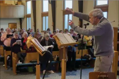  ?? ROGER LOKAR — THE NEWS-HERALD ?? Messiah director Kevin Donahue leads the Messiah Chorus in rehearsal. It’s the 70th year for the annual production in Lake County and Donahue’s eighth as its director.