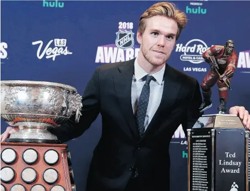  ?? JOHN LOCHER / THE ASSOCIATED PRESS ?? Edmonton Oilers’ Connor McDavid with the Art Ross Trophy and the Ted Lindsay Award Wednesday night.