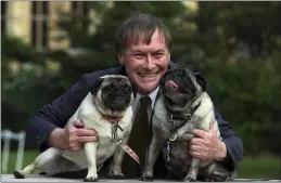  ?? GEOFF CADDICK — PA ?? Conservati­ve MP David Amess with his pugs, Lily and Boat, at the Westminste­r Dog of the Year competitio­n at Victoria Tower Gardens in London.