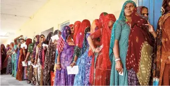  ?? REUTERS ?? Worth the wait: Women stand in a queue at a polling station in Barmer on Friday.